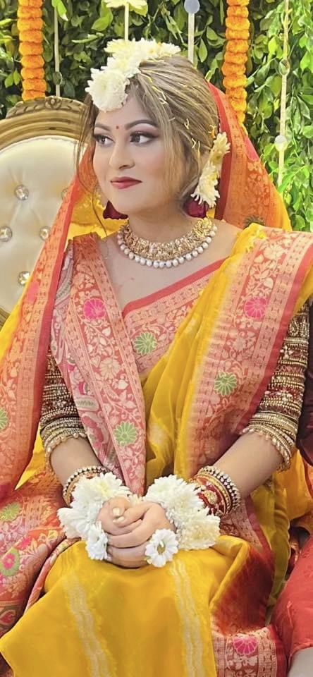 Bride with her soon-to-be husband, at groom's holud ceremony